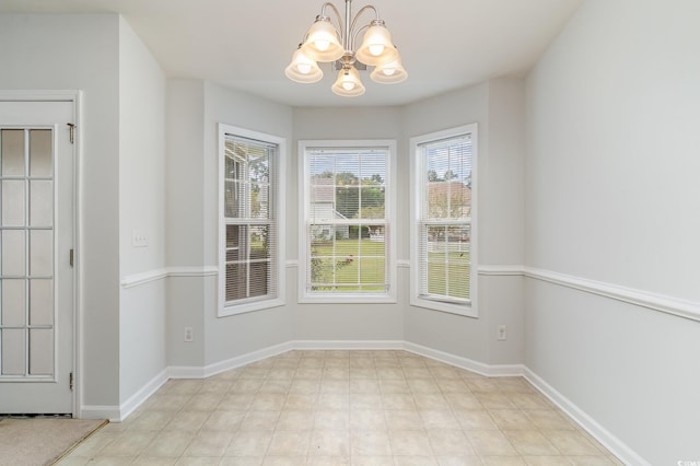 unfurnished dining area featuring a notable chandelier