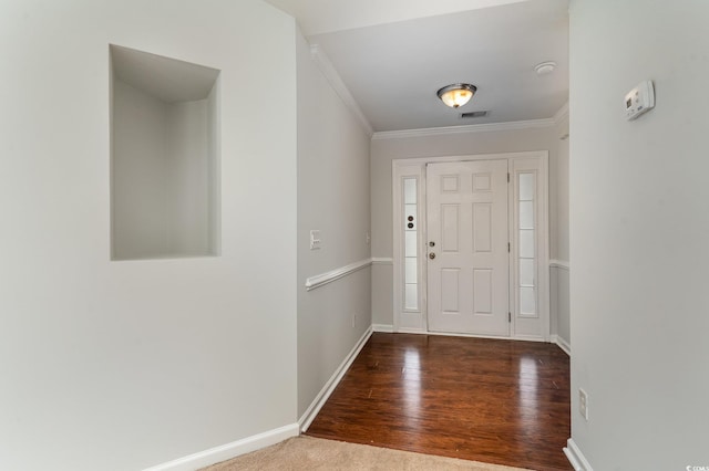 foyer with dark hardwood / wood-style floors and crown molding