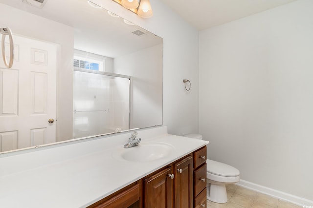 bathroom featuring toilet, vanity, tile patterned floors, and an enclosed shower