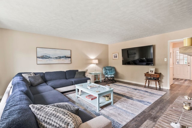 living room with a textured ceiling and hardwood / wood-style flooring