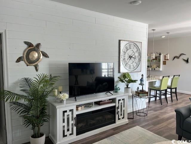 living area with wood finished floors and baseboards
