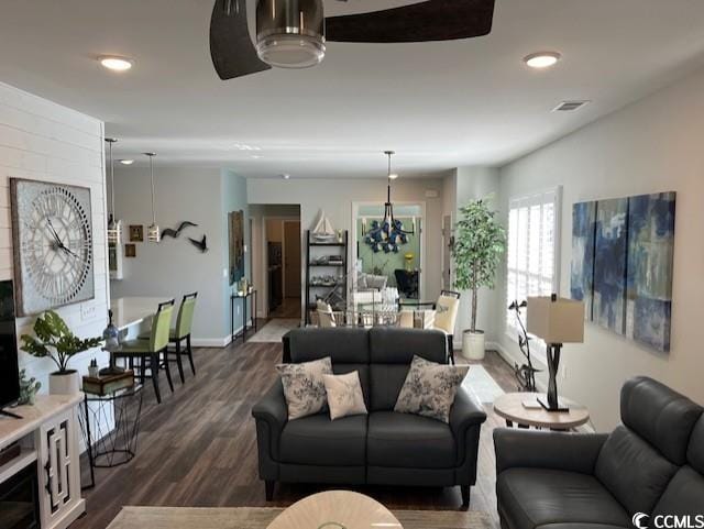living area featuring baseboards, recessed lighting, dark wood finished floors, and visible vents