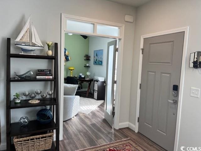 entryway with baseboards and wood finished floors