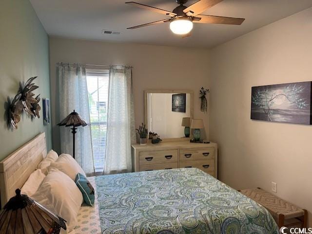 bedroom with a ceiling fan and visible vents