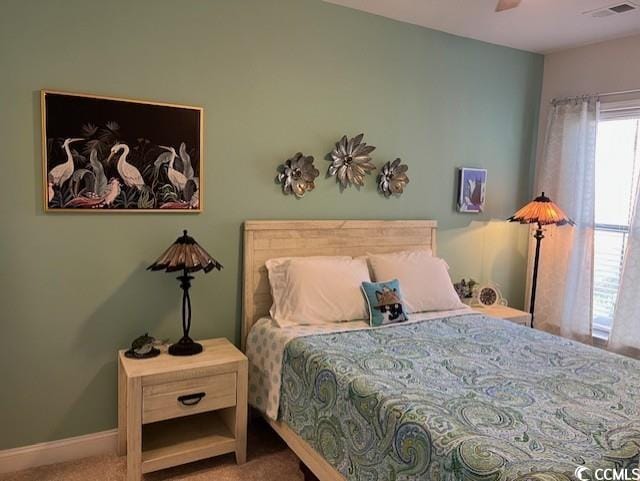 bedroom featuring visible vents, baseboards, a ceiling fan, and carpet floors