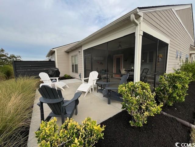 view of patio featuring a sunroom
