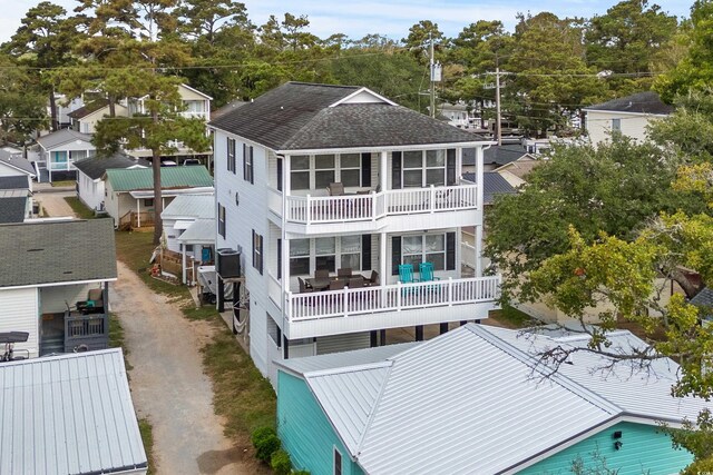 back of property featuring a balcony