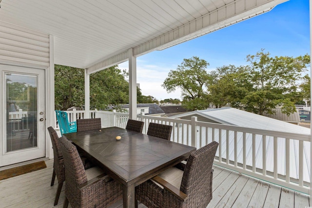 wooden terrace with outdoor dining space