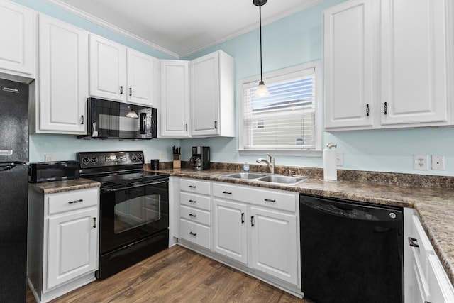 kitchen with black appliances, a sink, dark wood finished floors, white cabinets, and crown molding