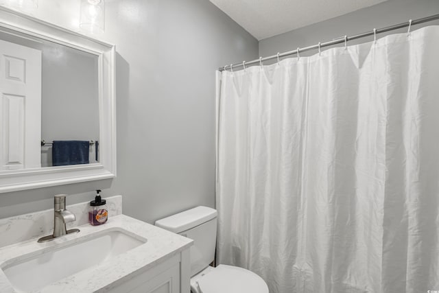 bathroom with curtained shower, toilet, a textured ceiling, and vanity