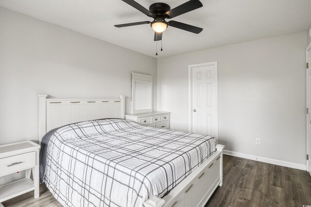 bedroom featuring ceiling fan and dark hardwood / wood-style floors