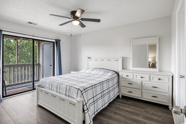 bedroom with a textured ceiling, dark wood-type flooring, ceiling fan, and access to exterior