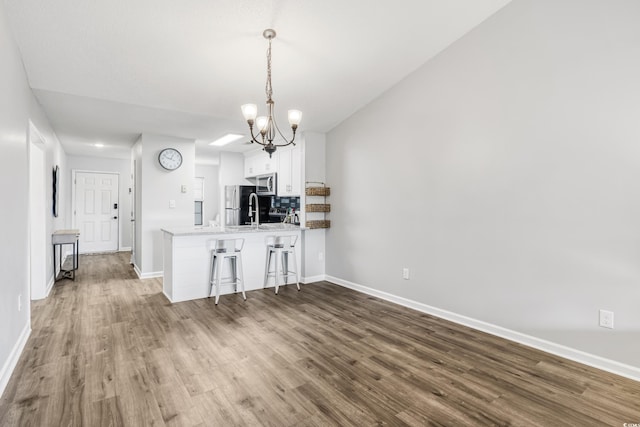 unfurnished dining area featuring dark wood-type flooring and a chandelier