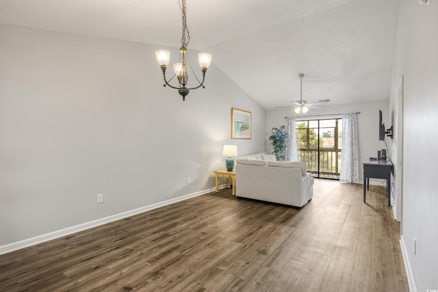 unfurnished living room featuring lofted ceiling, ceiling fan with notable chandelier, wood-type flooring, and a textured ceiling