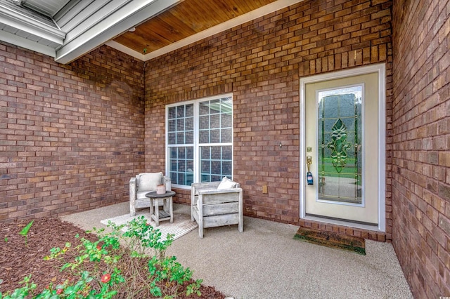 view of exterior entry featuring a patio