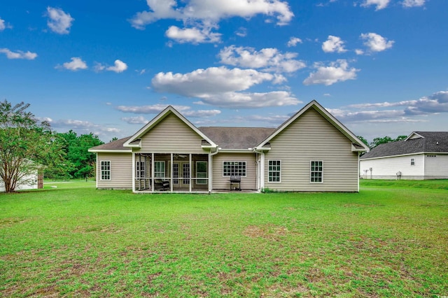 back of house featuring a lawn and a sunroom