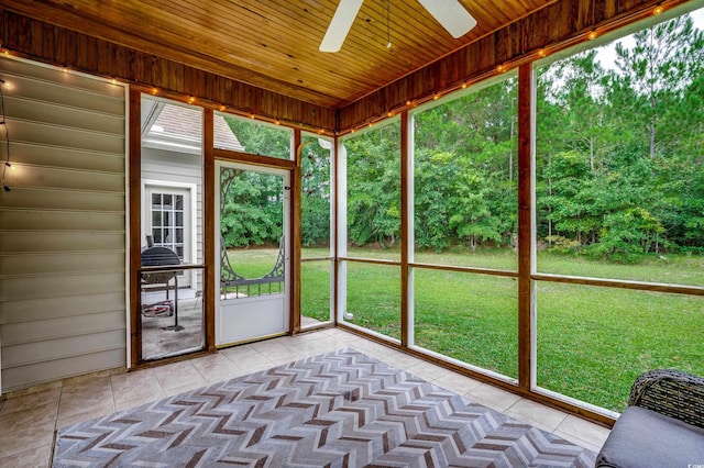 unfurnished sunroom with ceiling fan and wooden ceiling