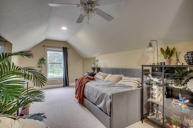 carpeted bedroom featuring lofted ceiling and ceiling fan