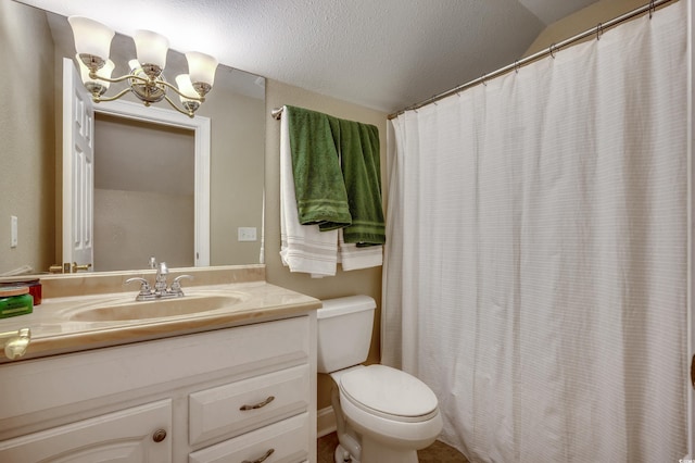 bathroom featuring a textured ceiling, vanity, and toilet