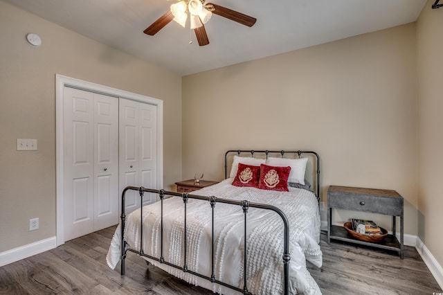 bedroom featuring ceiling fan, hardwood / wood-style flooring, and a closet