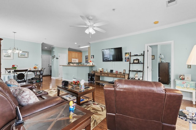 living room with ornamental molding, light hardwood / wood-style floors, and ceiling fan