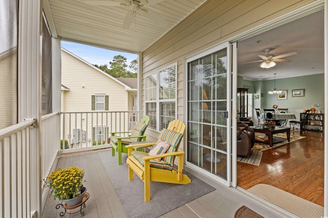 sunroom / solarium featuring ceiling fan