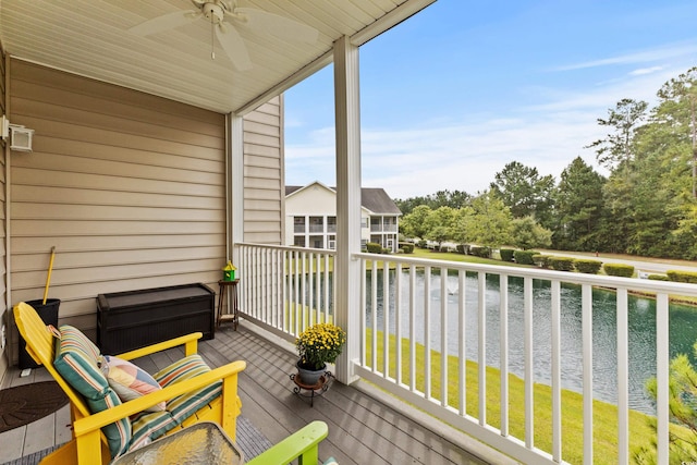 balcony with ceiling fan and a water view