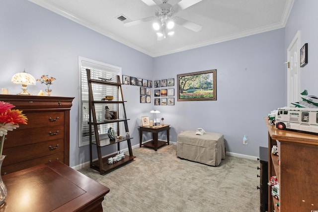 sitting room featuring ceiling fan, ornamental molding, and carpet flooring