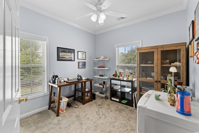 office space with ceiling fan, light colored carpet, ornamental molding, and a wealth of natural light