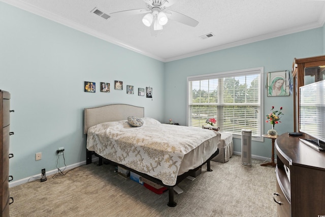 carpeted bedroom with ceiling fan, a textured ceiling, and ornamental molding