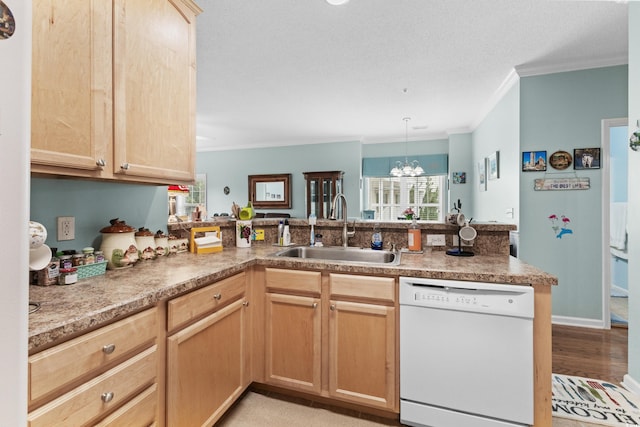 kitchen featuring dishwasher, sink, kitchen peninsula, an inviting chandelier, and crown molding