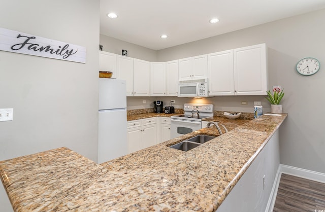 1009 World Tour Blvd Unit 301, Myrtle Beach, SC 29579 - kitchen with white appliances, baseboards, dark wood-type flooring, white cabinets, and a sink