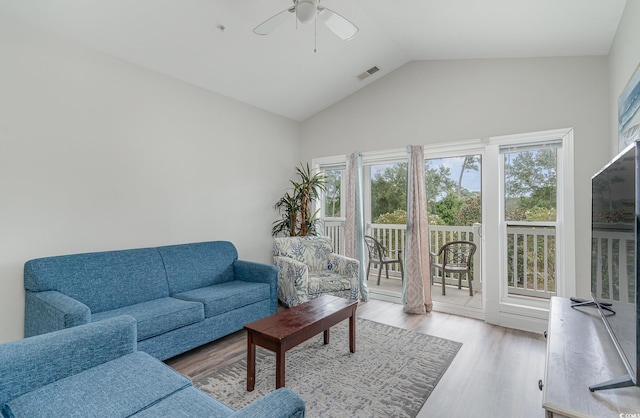 living room with ceiling fan, light hardwood / wood-style flooring, and lofted ceiling