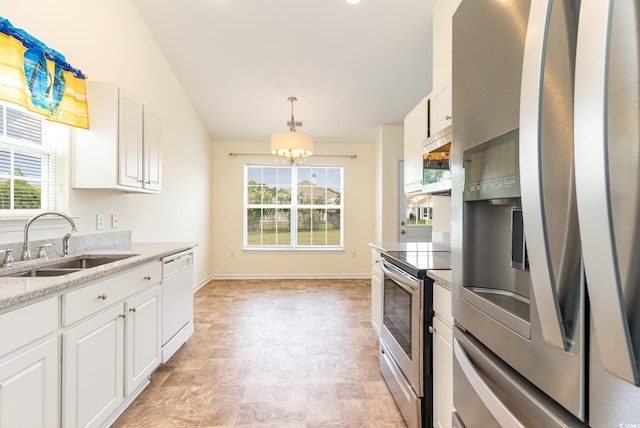 kitchen featuring sink, a chandelier, white cabinetry, stainless steel appliances, and light stone countertops