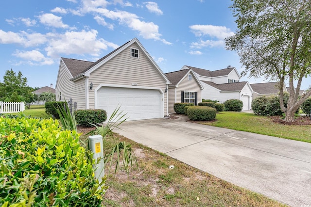 view of front of house featuring a front yard and a garage