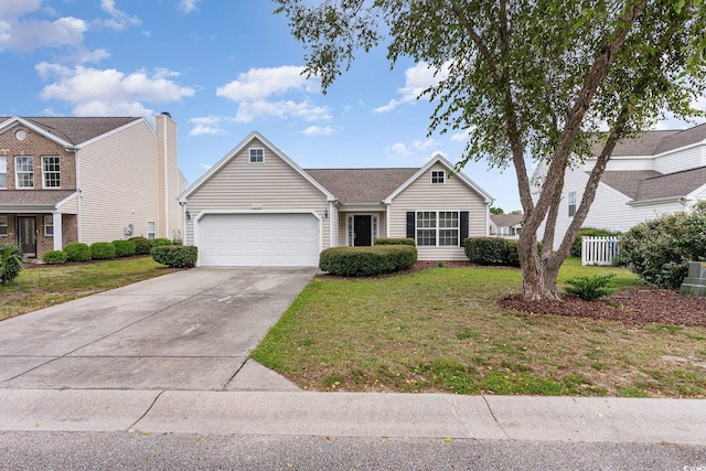 view of front of home featuring a front yard and a garage