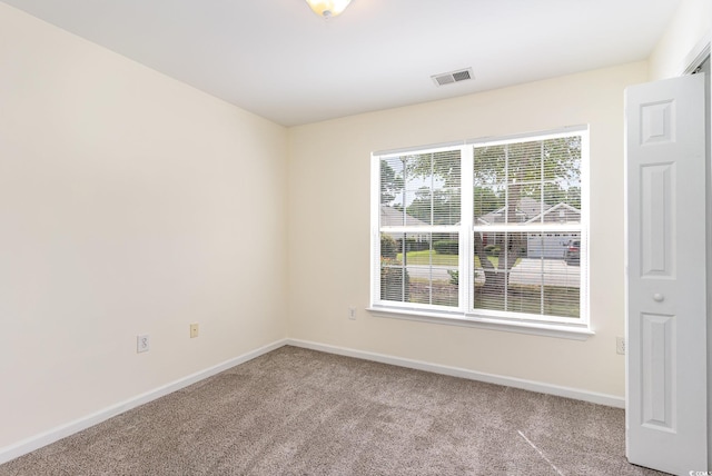 empty room with light colored carpet