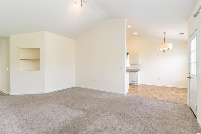 unfurnished living room with light carpet, vaulted ceiling, and a chandelier