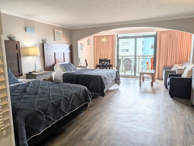 bedroom featuring wood-type flooring, a textured ceiling, and crown molding