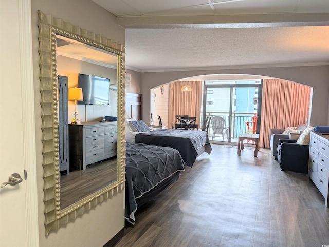 bedroom with a textured ceiling, hardwood / wood-style flooring, and crown molding