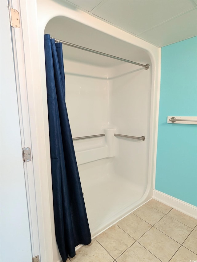 bathroom featuring a shower with curtain and tile patterned flooring