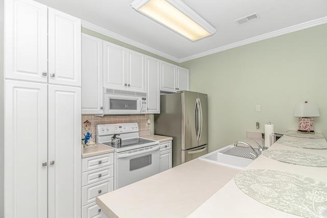 kitchen with sink, tasteful backsplash, white appliances, white cabinetry, and crown molding