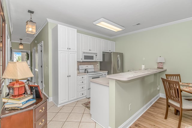 kitchen featuring ornamental molding, kitchen peninsula, white appliances, decorative light fixtures, and white cabinetry