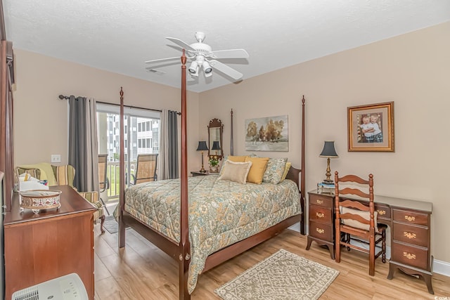 bedroom featuring a textured ceiling, access to exterior, ceiling fan, and light hardwood / wood-style flooring