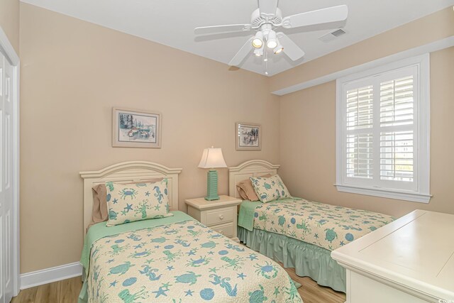 4516 N Plantation Harbour Dr Unit H-12, Little River, SC 29566 - bedroom with light wood-style floors, baseboards, and a ceiling fan