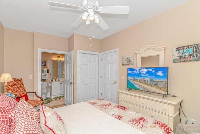 bedroom featuring light tile patterned floors, ceiling fan, and ensuite bathroom