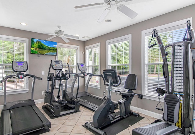 exercise room featuring ceiling fan and light tile patterned flooring