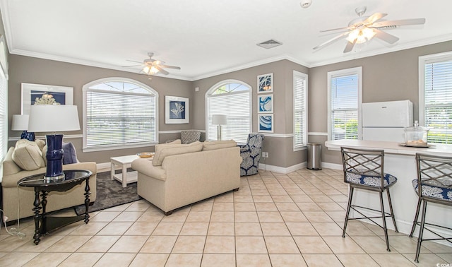 tiled living room featuring ceiling fan and ornamental molding