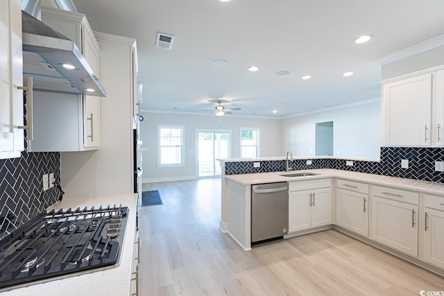 kitchen with gas cooktop, stainless steel dishwasher, wall chimney exhaust hood, light hardwood / wood-style flooring, and white cabinetry