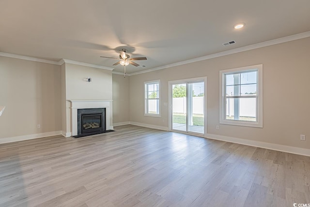 unfurnished living room featuring light hardwood / wood-style flooring, ceiling fan, and crown molding